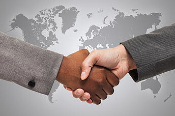 People_Shaking_Hands_in_front_of_Map_of_World People_Shaking_Hands_in_front_of_Map_of_World